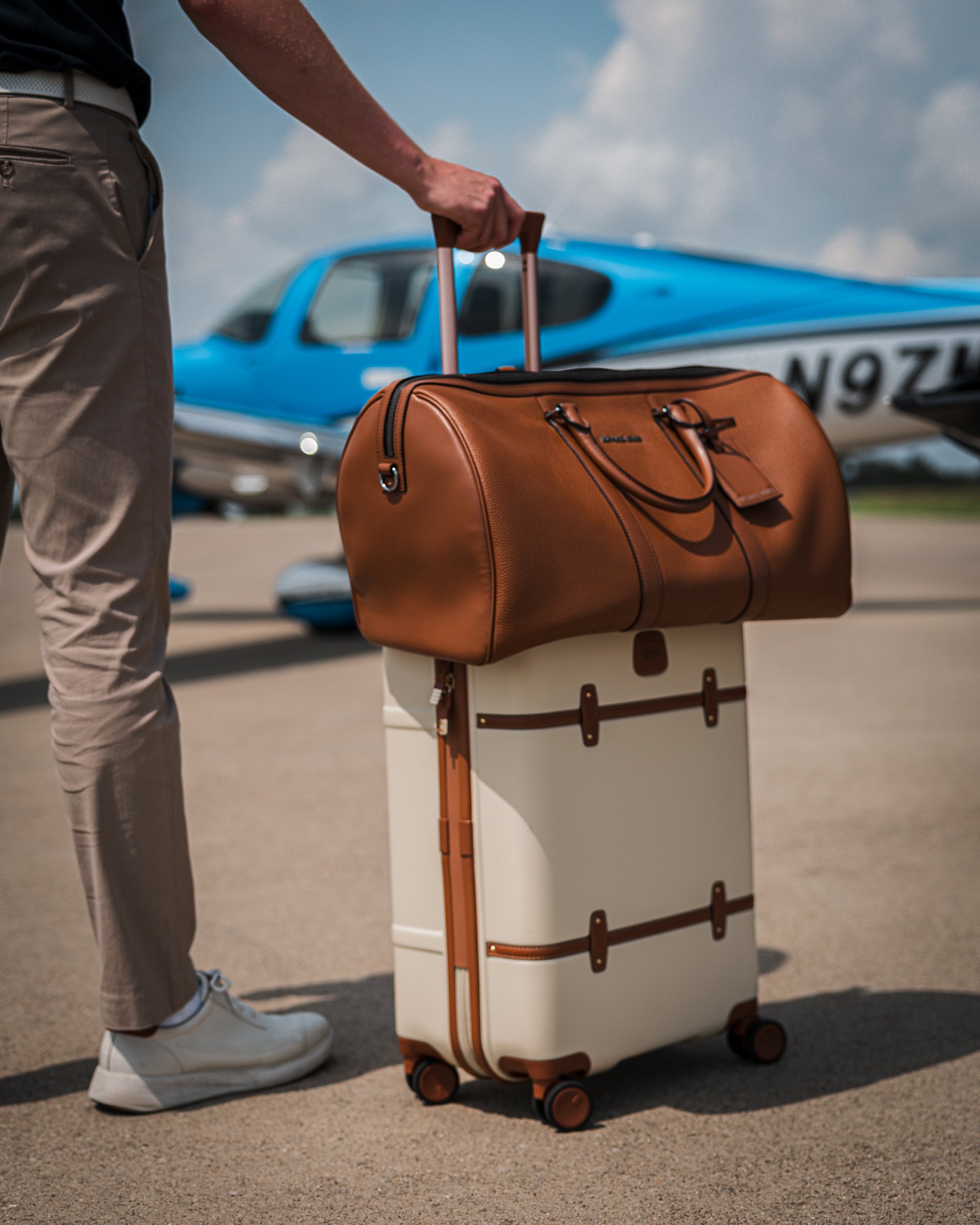 An owner carrying leather bags out to the aircraft