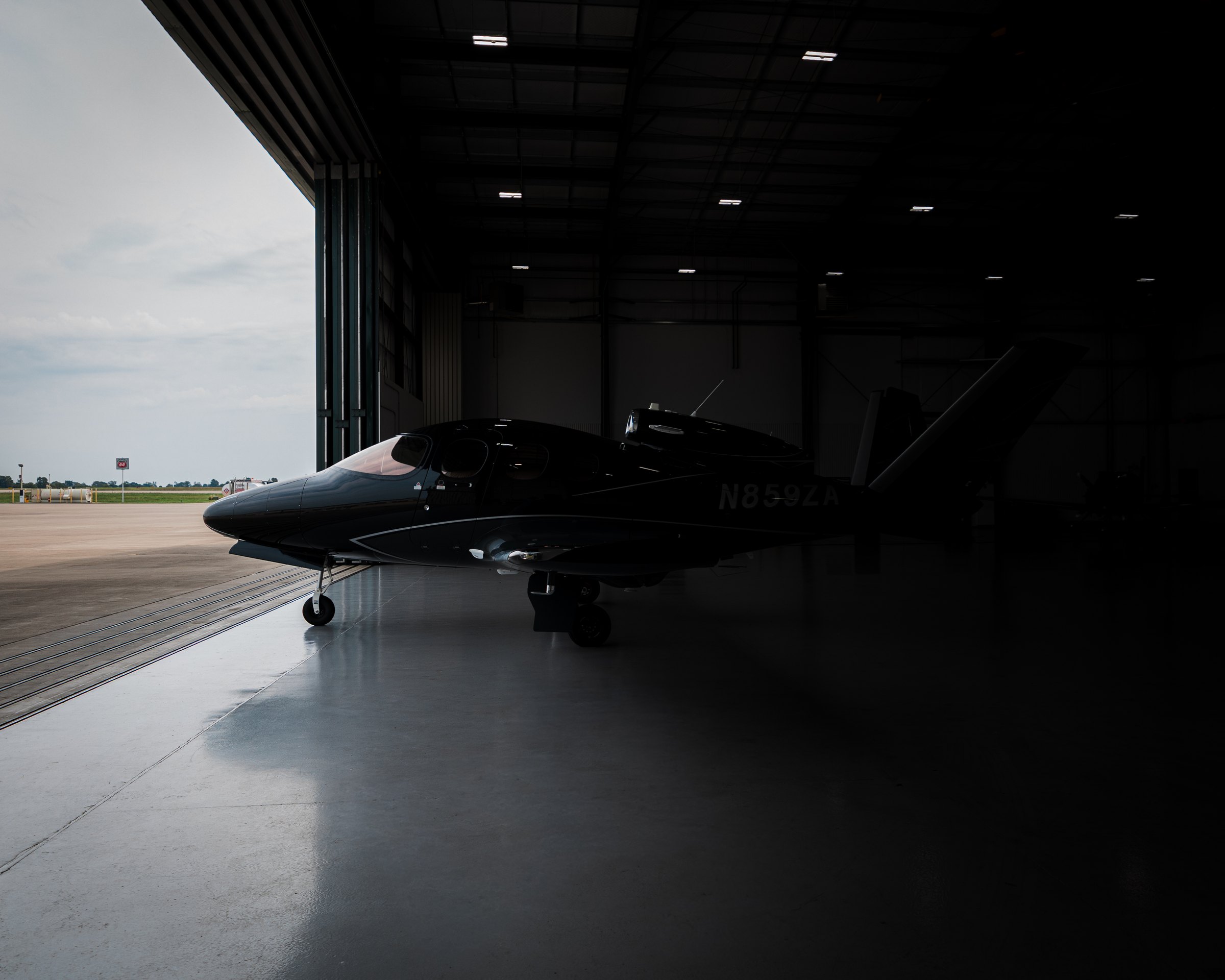 A Cirrus Vision Jet emerging from the hangar
