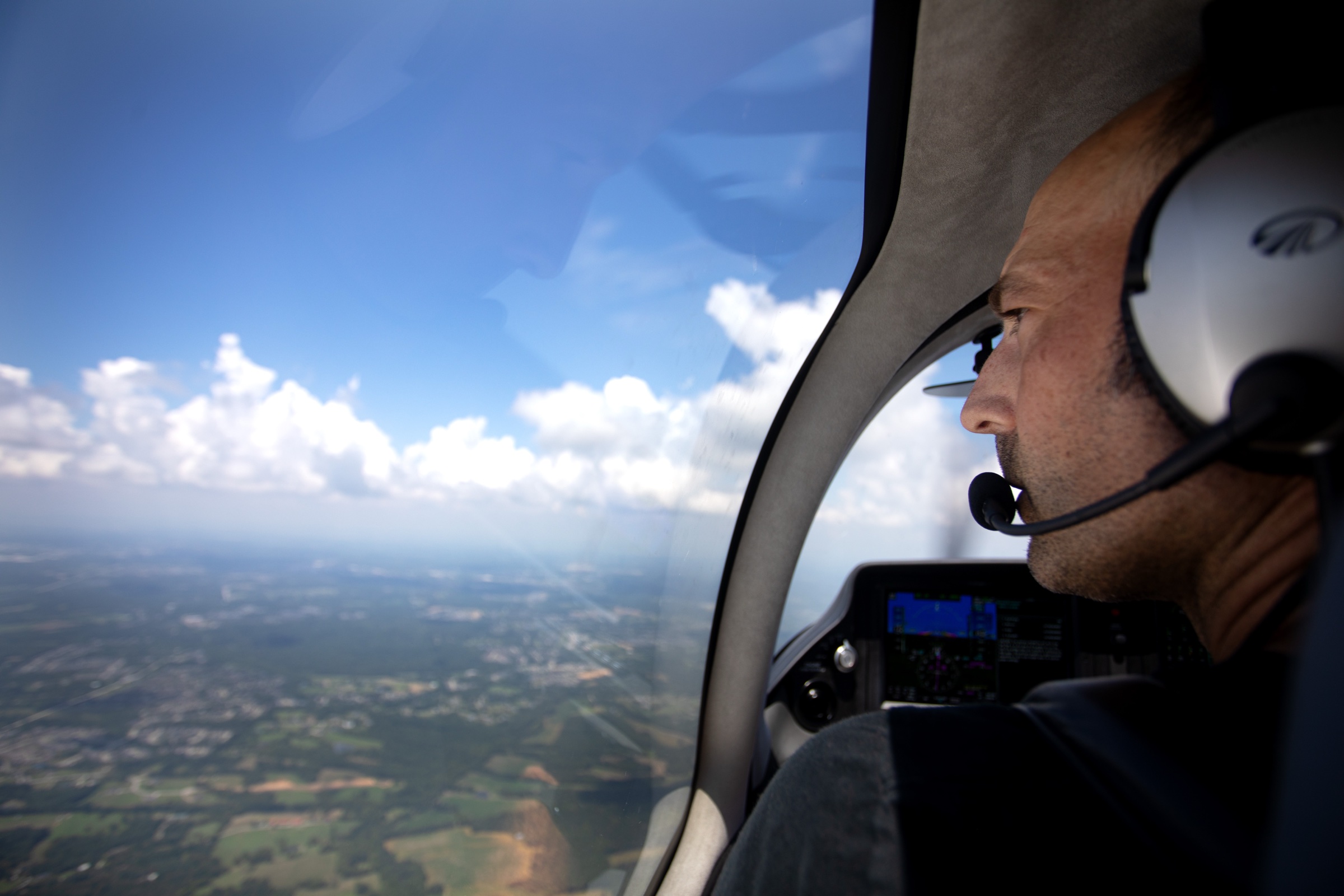 Pilot looking out at clouds in flight