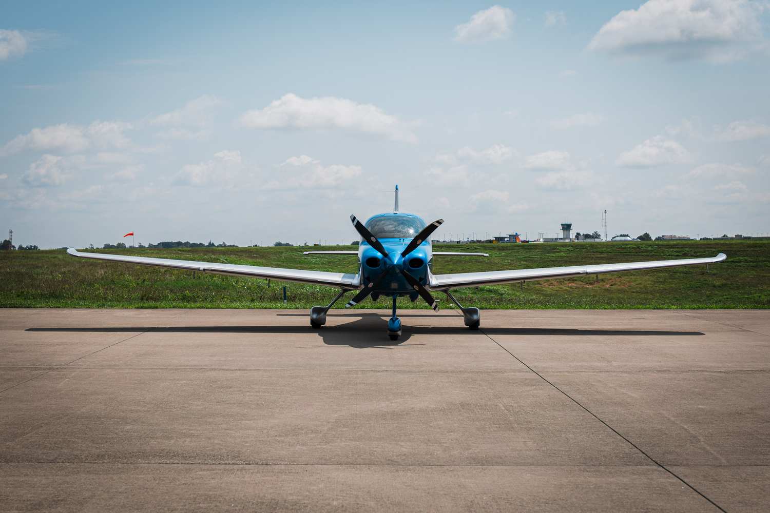 A Cirrus SR22T on the runway under an open sky