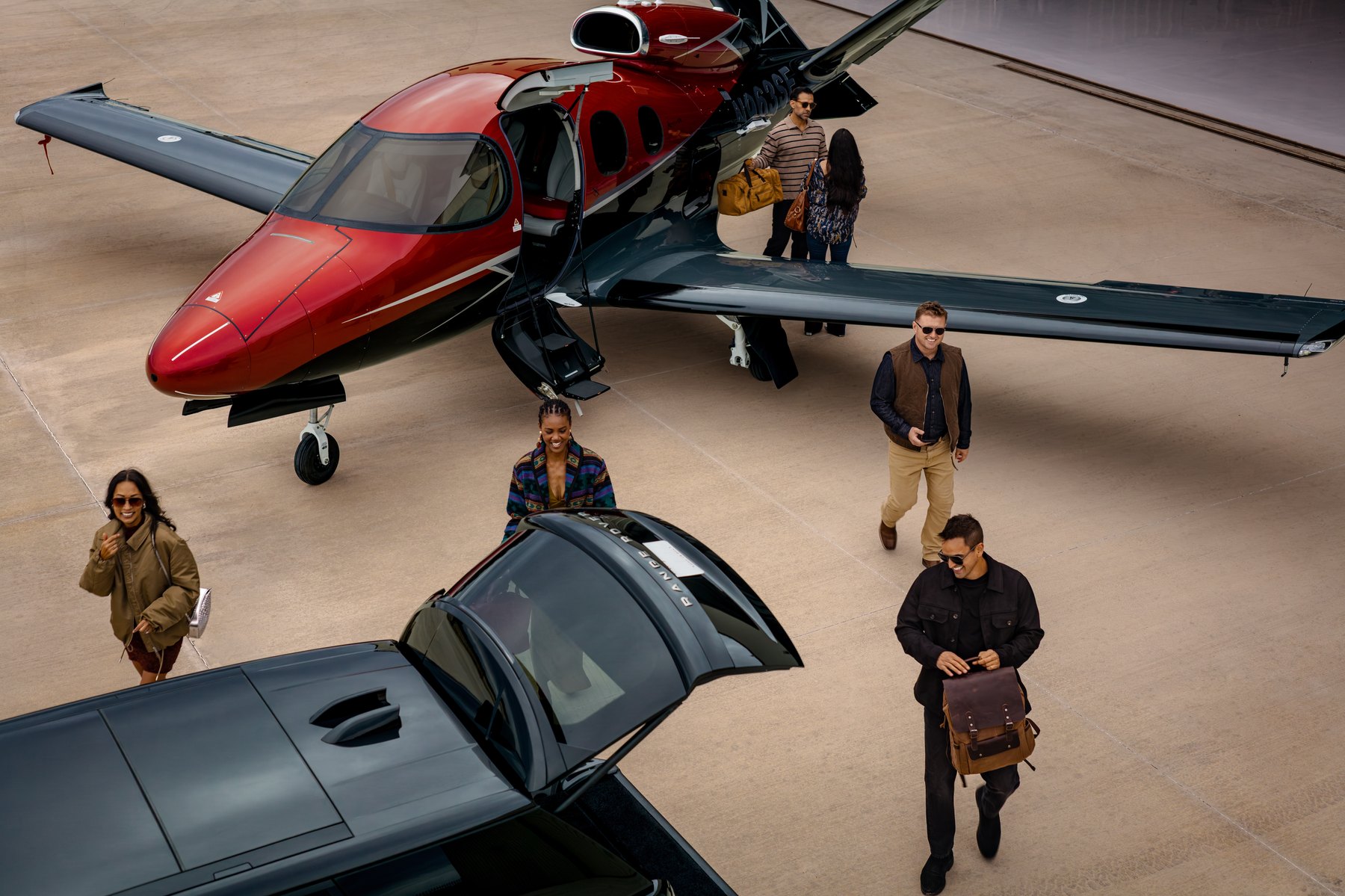 A Cirrus Vision Jet on the ramp with passengers arriving