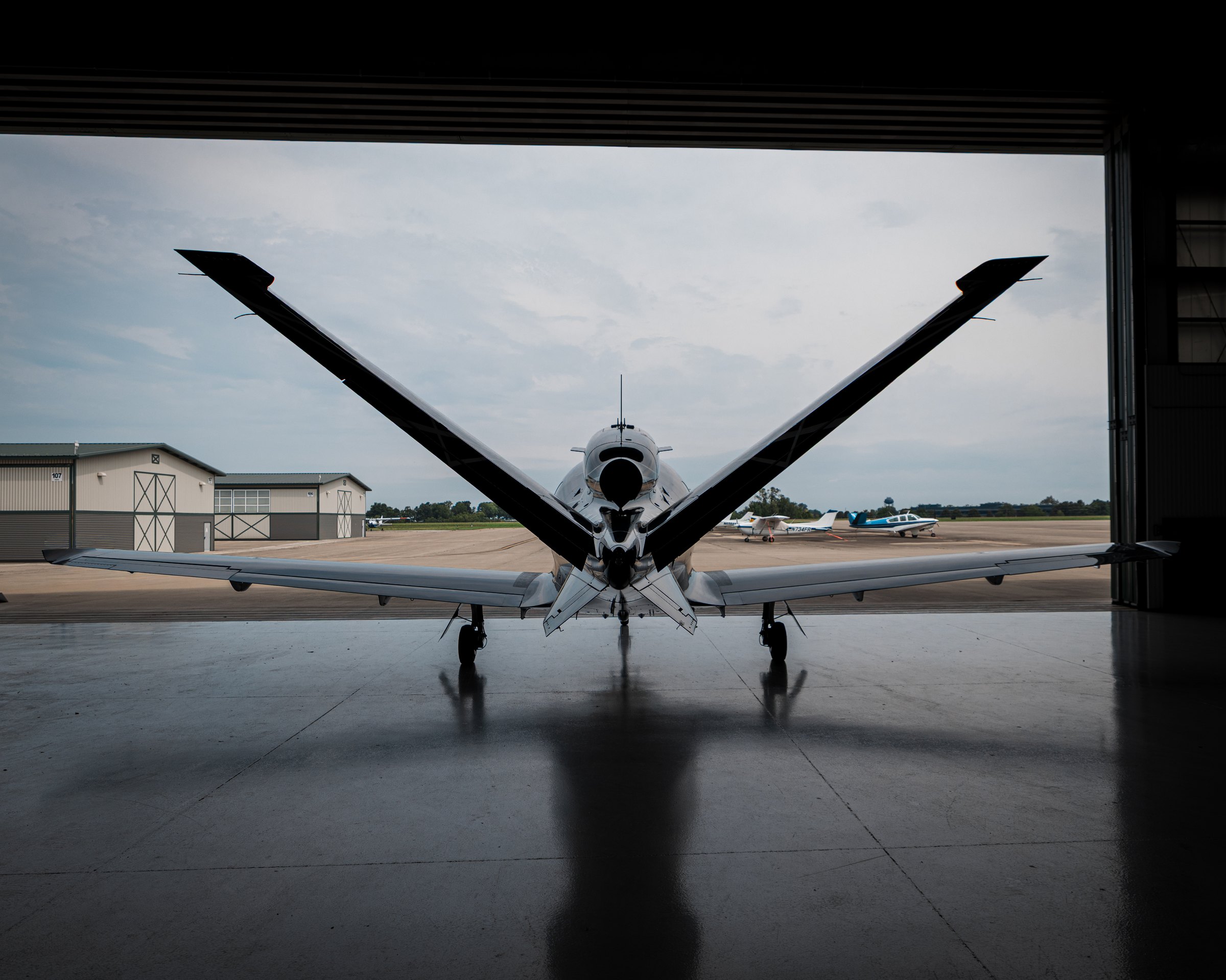 A Cirrus Vision Jet in the hangar doorway at Blue Grass Airport
